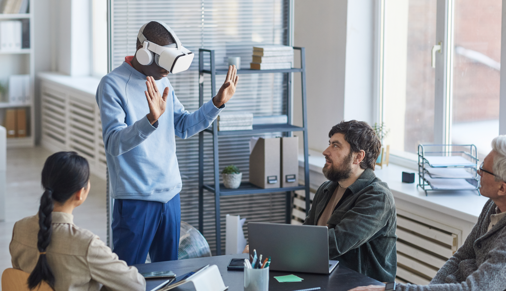 Types of software development game development example showing business professional using VR headset for corporate training in modern office environment