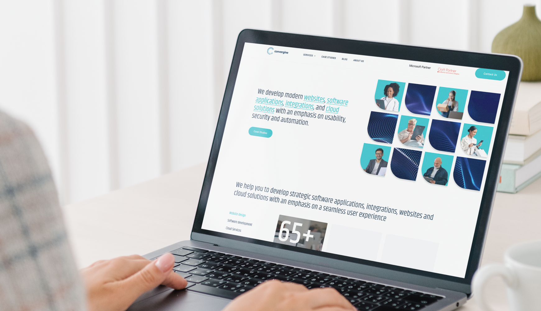 A person using a laptop to explore the benefits of business integration on a website.