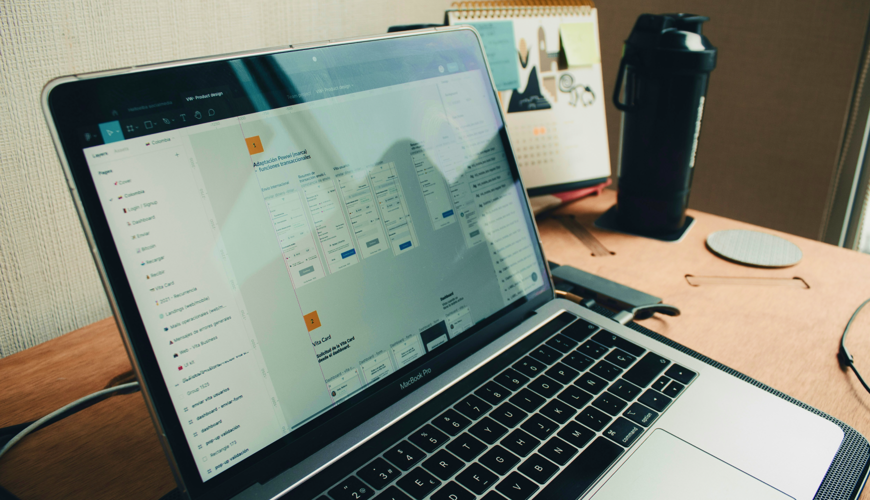 Website cost planning workspace with laptop displaying project management dashboard and development workflow
