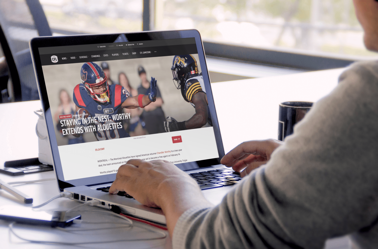 Macbook mockup of a man working at an office table 2